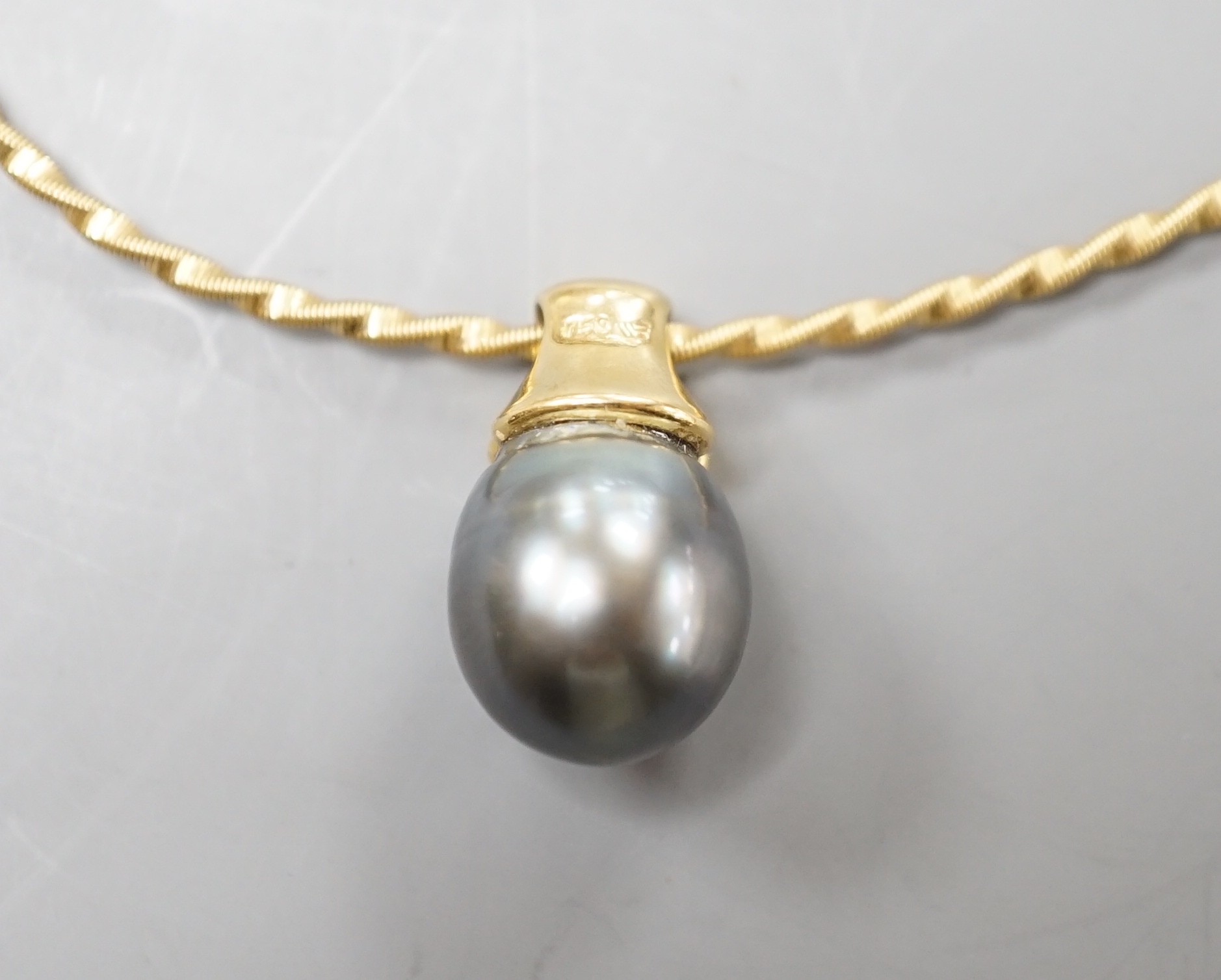 A modern 18k, cultured Tahitian pear and diamond chip set pendant, 19mm, on a 750 yellow metal necklet, approx. 36cm, gross weight 10.3 grams.